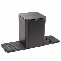 Black rectangular trash can with lid and stability flap on a white background