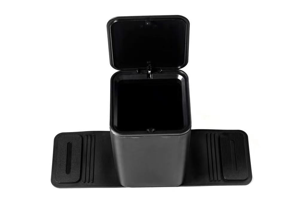 Black medium sized rectangular car trash can with stability flap and open lid on a white background